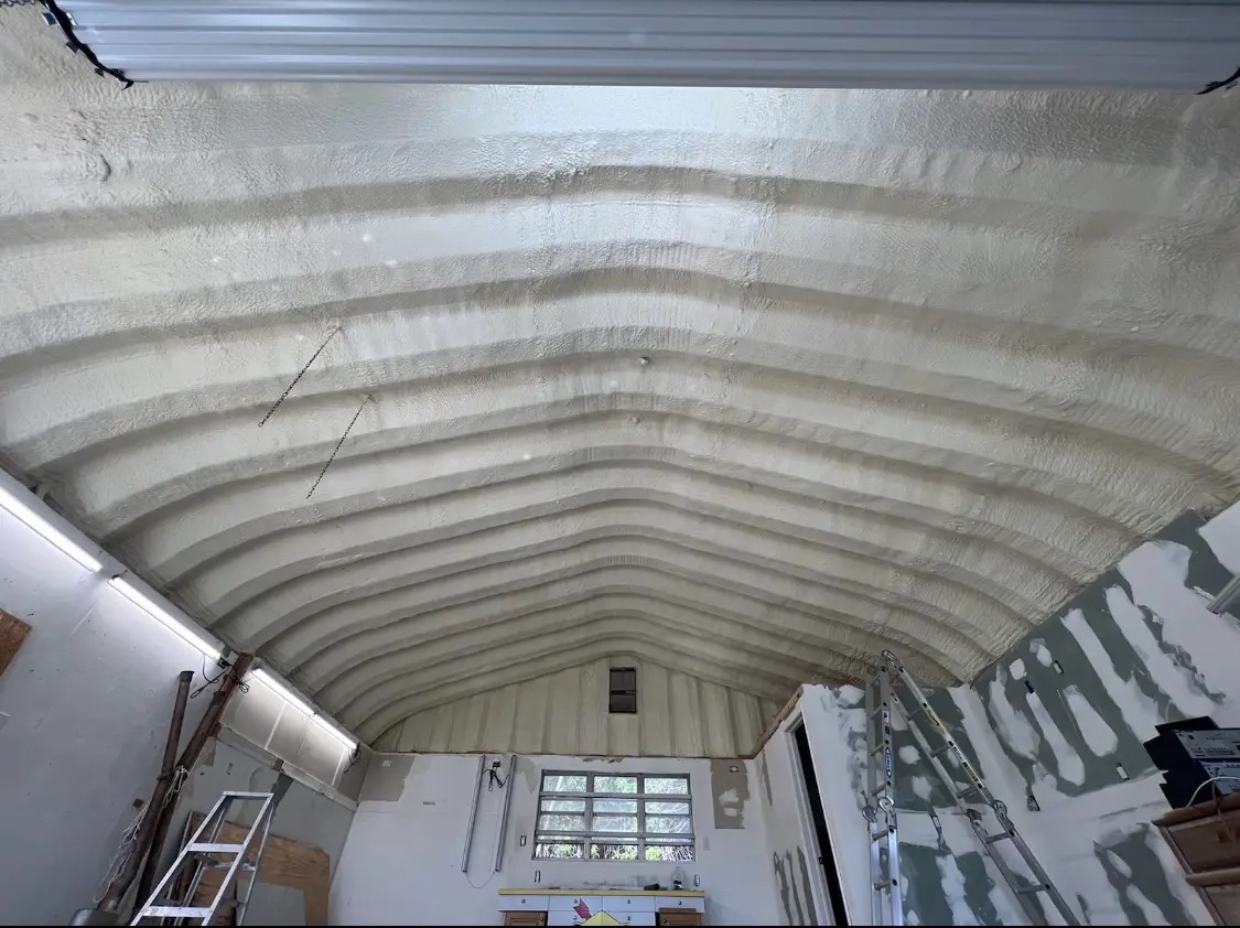 Spray polyurethane foam applied to the underside of a metal roof deck in Childress